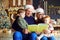 Grandparents read a book to children in Christmas