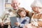 Grandparents reading book with grandson