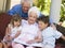 Grandparents reading to grandchildren