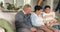 Grandparents, relax and happy family together in lounge for bonding in living room, home or watching a tv show or movie