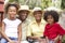 Grandparents Relaxing In Garden With Grandchildren