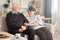 Grandparents sitting on couch