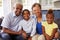 Grandparents and their young grandchildren at home, portrait