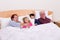 Grandparents Watching TV in the bed with their Grand kids