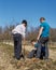 Grandson, father and grandfather planting a plum tree in an orchard