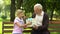 Grandson gives birthday present to grandfather, love and attention to old people