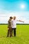 Grandson and grandfather in field