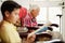 Grandson And Grandpa Reading Book And Relaxing At Home