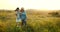 Grandson and granfather spending time together on summer meadow