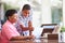 Grandson Helping Grandmother With Laptop