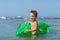 Grandson playing and splashing in the sea water. Portrait of happy little kid boy on the beach of