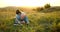 Granfather and grandson laying in grass and reading a book