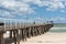 The grange jetty with a blue sky and white fluffy clouds at Gran