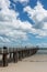 The grange jetty with a blue sky and white fluffy clouds at Gran