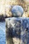 Granite ball on a pedestal covered with frost