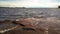 Granite beach with waves and dark water. Northern abstract natural background.