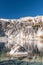Granite cliffs of Prusik Peak and moon above alpine lake Viviane