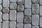 Granite cobblestoned pavement background. Full frame of regular square cobbles in rows