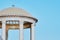 Granite columns of the rotunda support a dome with a transparent roof. Sun glare on the surface of natural stone. It