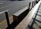 Granite decorative bench in the square. made of bright granite. The paving stones of the boardwalk of the promenade are protected