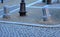 Granite decorative column in the square. made of bright granite. The paving stones of the boardwalk of the promenade are protected