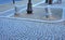 Granite decorative column in the square. made of bright granite. The paving stones of the boardwalk of the promenade are protected