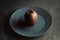 Granite-like sculpture of apple on a plate