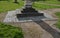 Granite natural paving of irregular shape, brown gray paving in the pedestrian zone in park near the bridge with stairs. garden pa