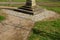 Granite natural paving of irregular shape, brown gray paving in the pedestrian zone in park near the bridge with stairs. garden pa