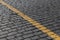 Granite pavement with a yellow stripe on the diagonal