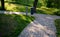 Granite paving of irregular sections of chipped stone around a park with green lawn gray color of the pedestrian path