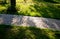 Granite paving of irregular sections of chipped stone around a park with green lawn gray color of the pedestrian path