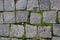 Granite paving stone background of the sidewalk. Abstract background of an old cobblestone street close-up