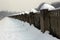 Granite pillars along the promenade marked by snow