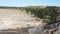 Granite quarry with mining equipment, waste rock dumps, aerial view