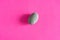 Granite smooth pebbles sea stones on pink background top view