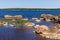 Granite snoes are on a lake coast. Monrepos Park summer landscape