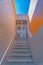 Granite stairs with wall-mounted handrails leading to a white iron single gate- San Francisco, CA