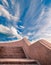 Granite stairway leaing up in fronbt of day sky with clouds, copyspace