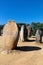 Granite standing stone, menhir, with other megalithic and neolithic standing stones at the Almendres Cromlech near Evora, Portugal