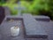 Granite tombstone in the shape of a cross with a candle