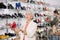 Granny choosing shoes while standing in salesroom of shoeshop