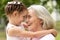 Granny and granddaughter posing outdoors