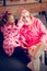 Granny and granddaughter wearing pink bathrobes taking sheet mask