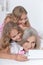 Granny with granddaughters using smartphone