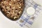 Granola on a baking sheet and yogurt on a light white background