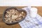 Granola on a baking sheet and yogurt on a wooden table.