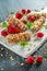 Granola bar with strawberries, raspberry honey and white chocolate on cutting board