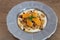 Granola bowl with soy yogurt,maple syrup, orange slices and mint leaves