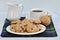 Granola chocolate chip cookies on a plate with coffee.  Macro with copy space